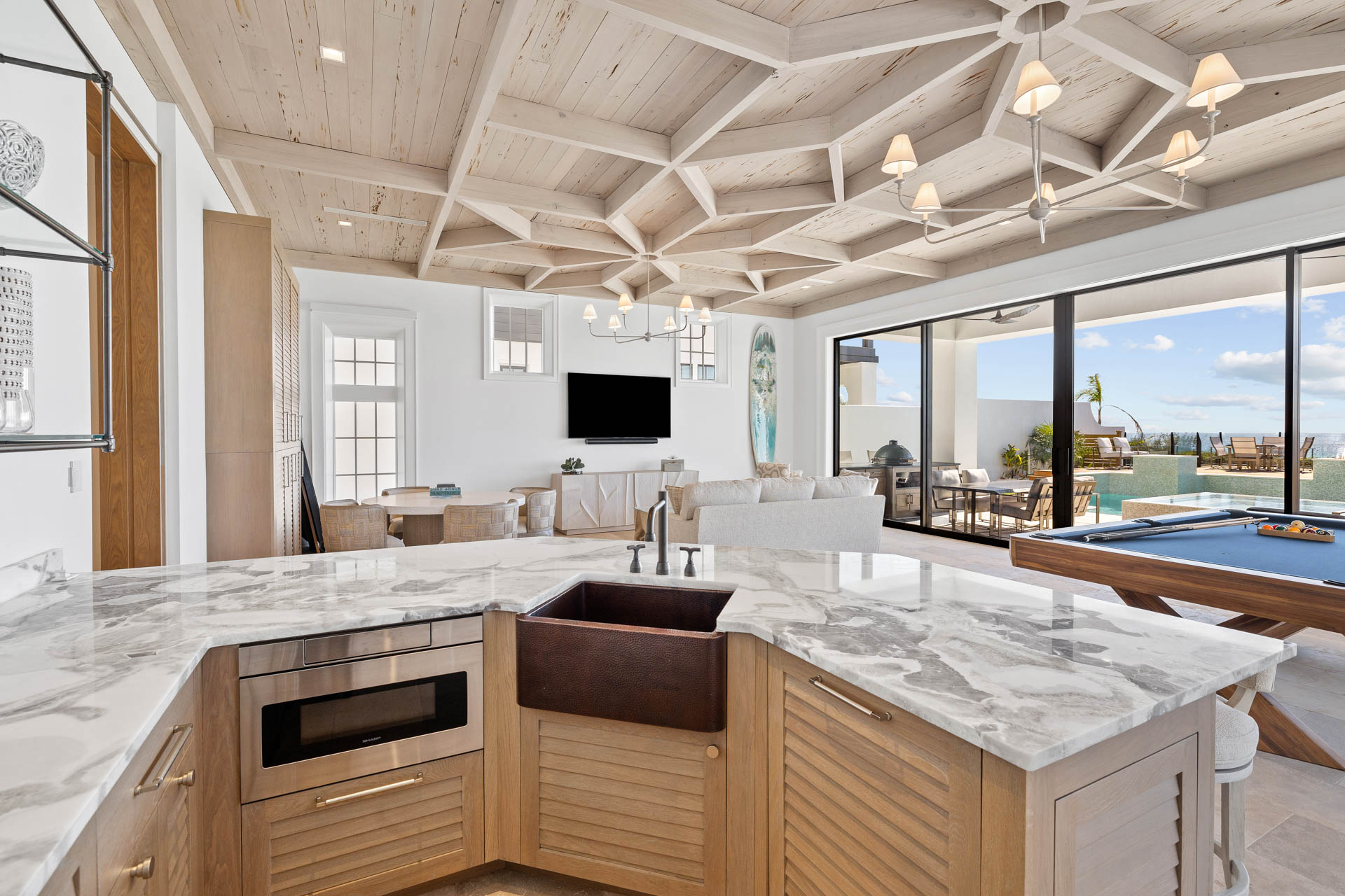 Celebrity-approved Destin interior design by Studio M features hand-hewn beams and innovative materials across 14,000 square feet of coastal luxury