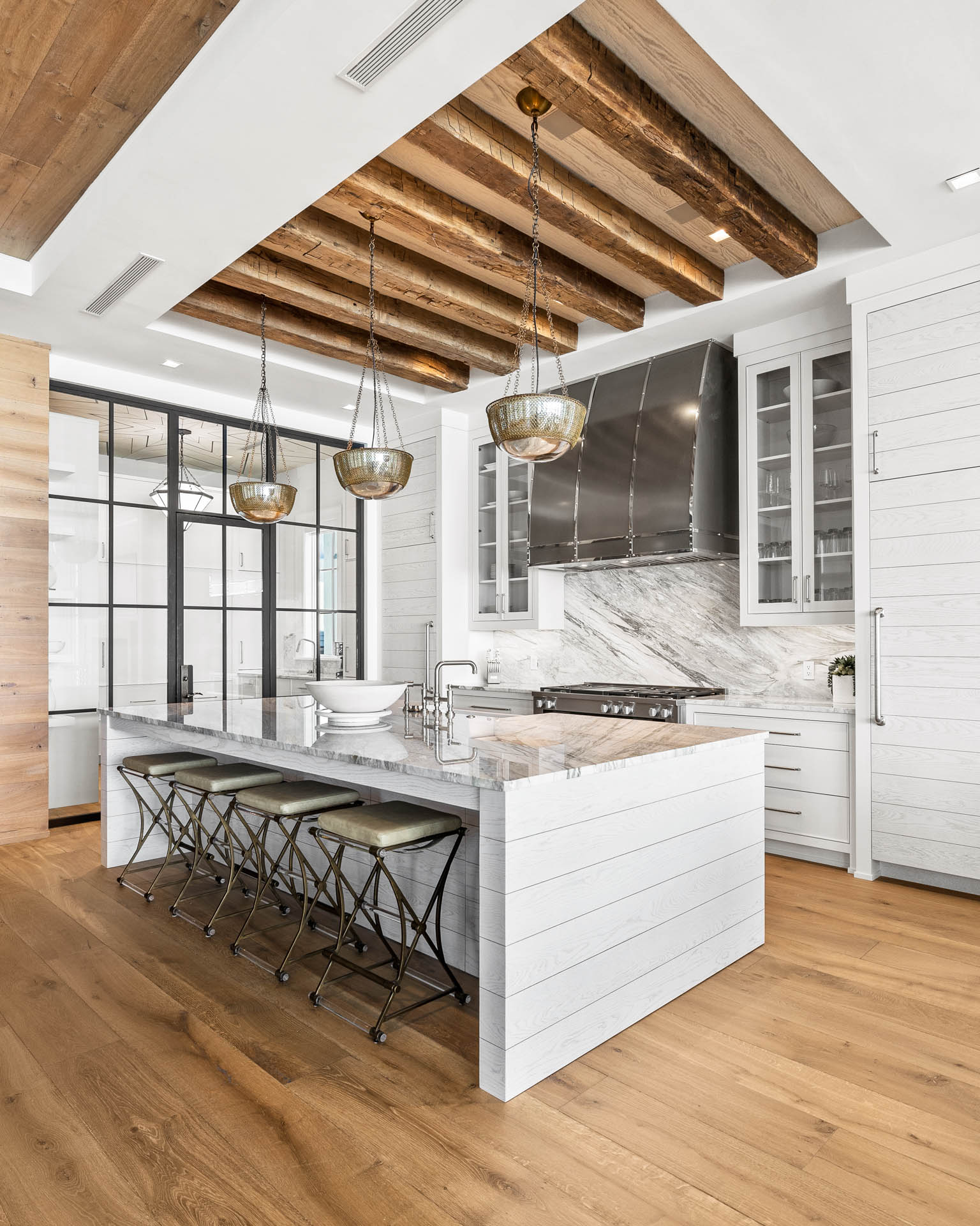 Celebrity-approved Destin interior design by Studio M features hand-hewn beams and innovative materials across 14,000 square feet of coastal luxury