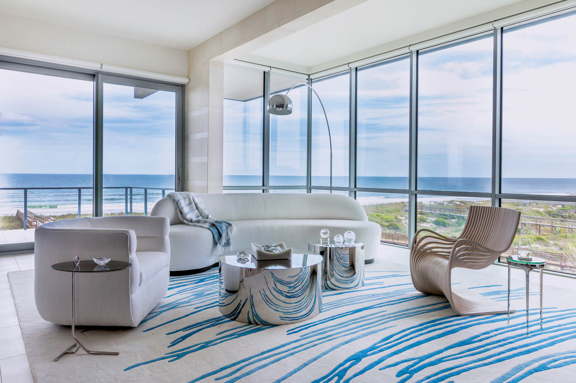 Studio M's award-winning interior design transforms narrow Fernandina Beach lot into luxurious three-story coastal home with modern aesthetics, custom blue accents, and innovative space utilization